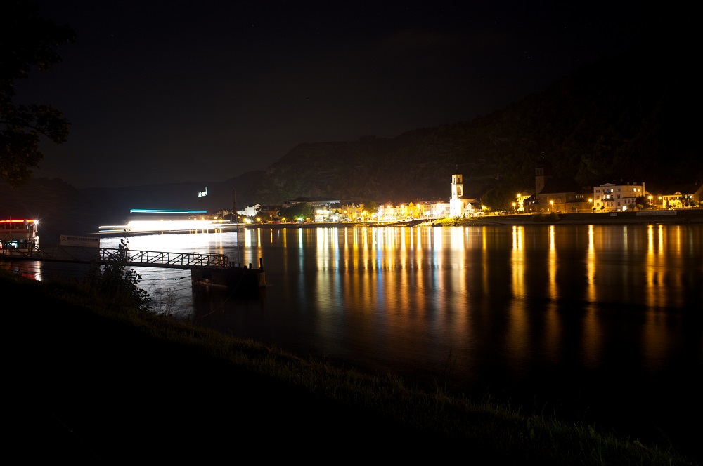 Een pontje dat de Rijn overvaart geeft een streep licht weer op een foto met lange sluitertijd